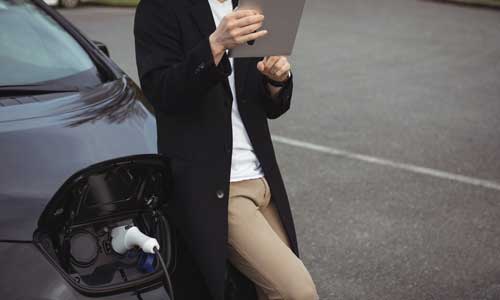 Clients reviewing electric fleet budget options on an iPad